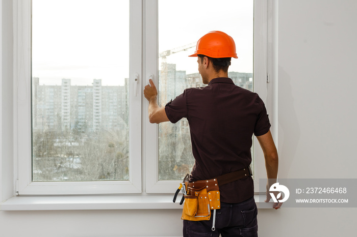 Carpenter repairing window frames, home is being updated to be sold