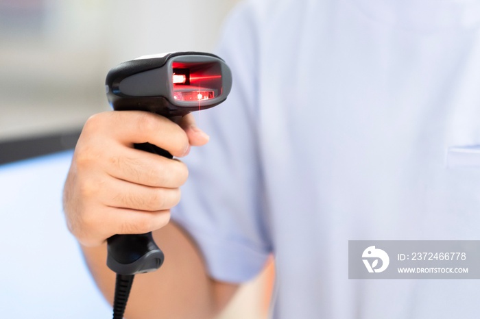 Pharmacist scanning barcode of drug in a pharmacy