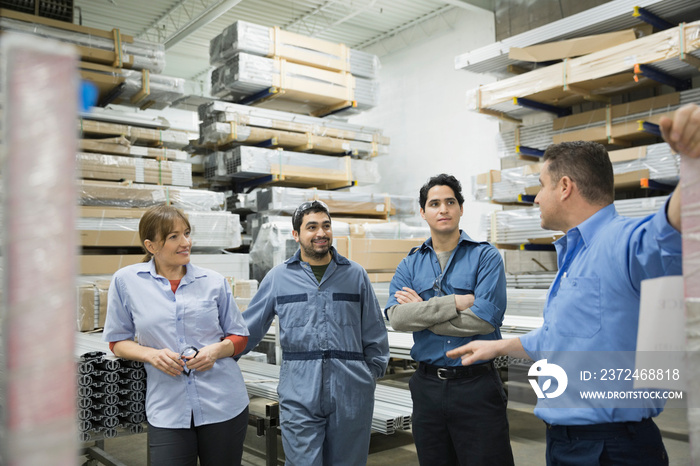 Manual workers meeting in warehouse