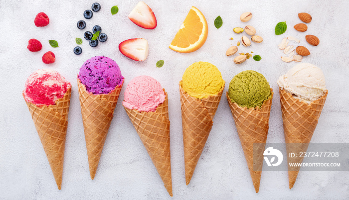 Various of ice cream flavor in cones blueberry ,pistachio ,almond ,orange and cherry setup on white 