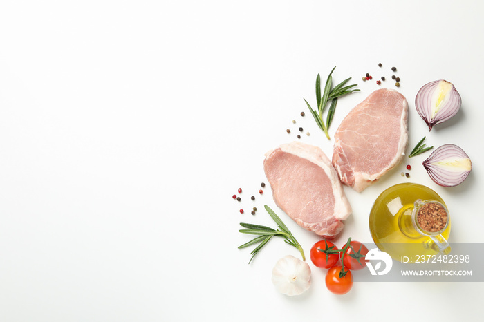 Composition with raw meat and ingredients on white background, top view