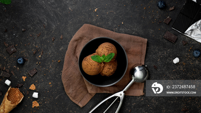 Top view of summer dessert with chocolate flavour ice-cream in black bowl