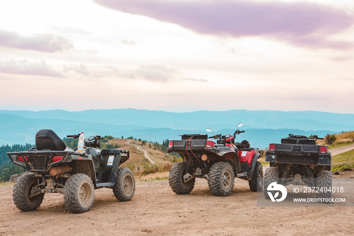 people riding on all terrain vehicle by mountains