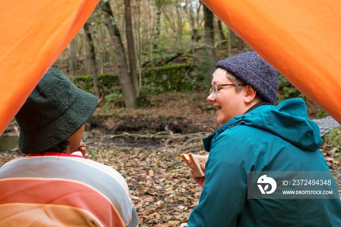 Female friends camping in forest