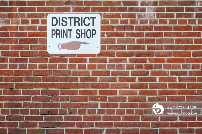 Print shop sign on brick wall