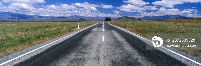 Straight Highway and Fair Weather Cumulus Clouds