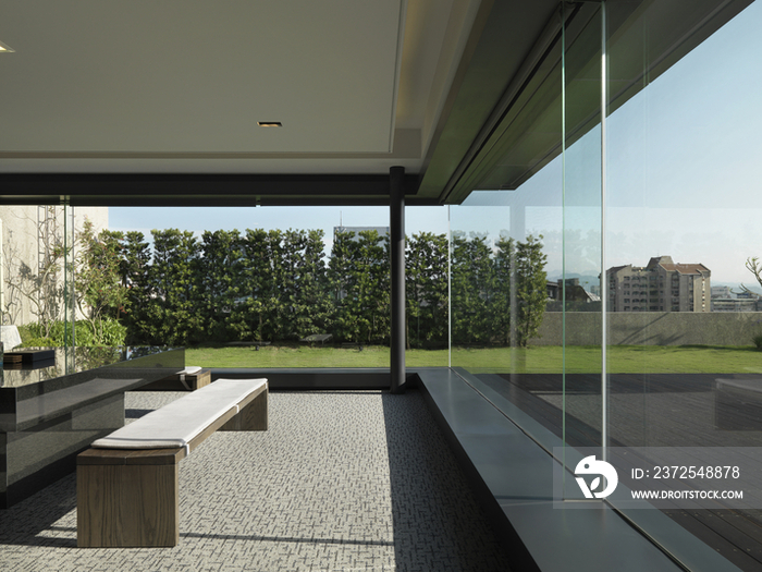 Wooden bench in modern office with glass walls