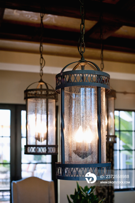 Detail shot of lit hanging candle lights at home