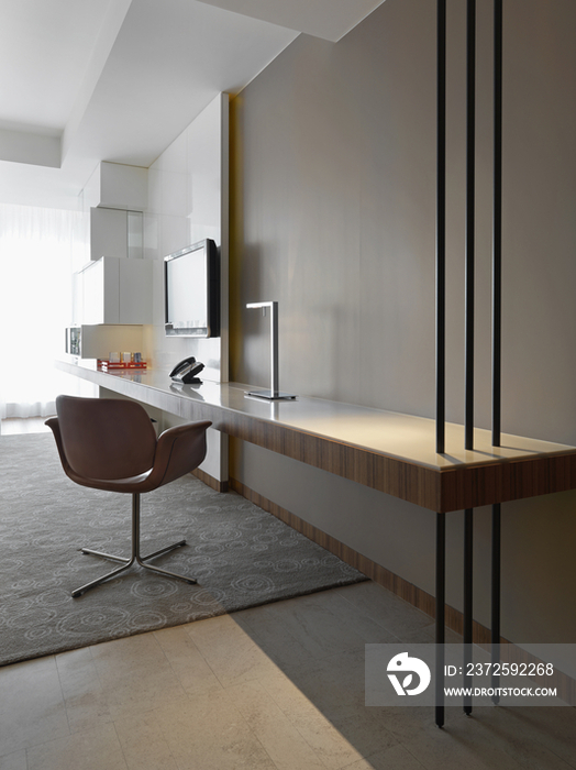 Modern chair near wooden counter in hotel room