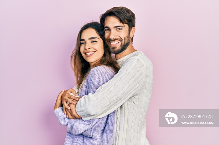 Young hispanic couple wearing casual clothes looking to side, relax profile pose with natural face a