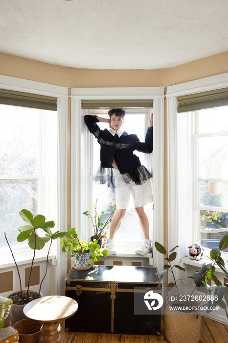 portrait of non-binary caucasian person with short brown hair at home