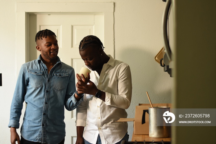 USA, Louisiana, Gay couple smelling homemade aromatic candle at home