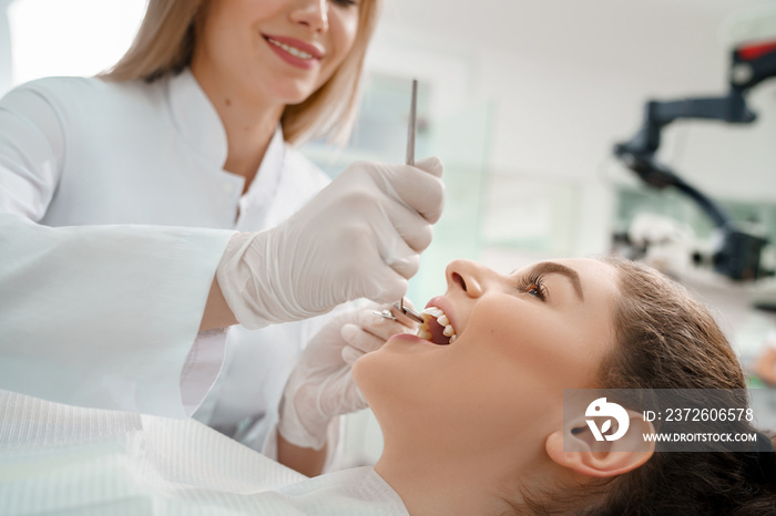 Female patient lying on dental chair with open mouth