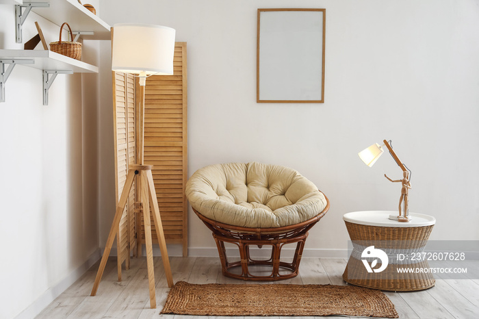 Interior of stylish living room with armchair, lamps and wicker coffee table