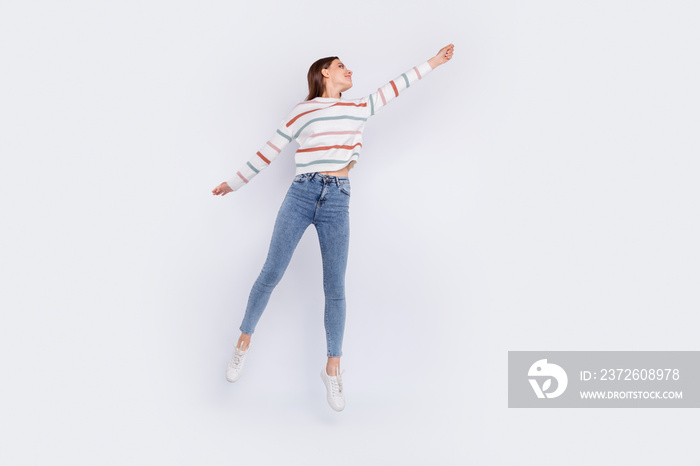 Full body photo of pretty lady holding her arm wearing striped sweater denim jeans isolated over whi