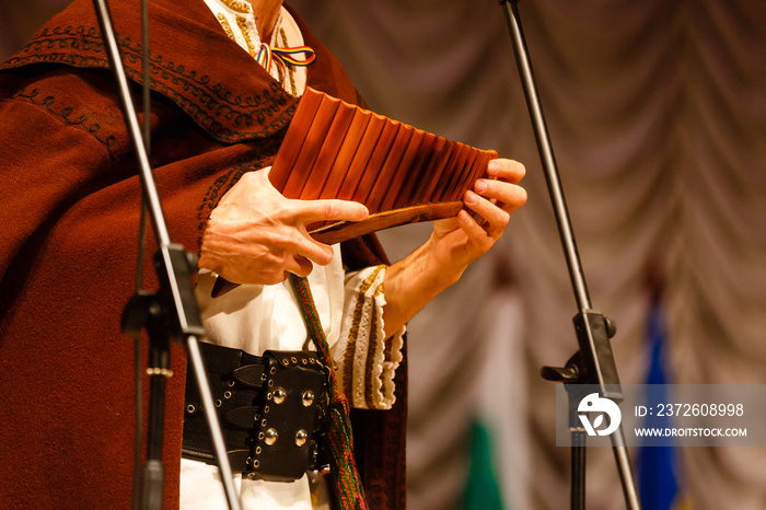 Musician playing panpipe. Musical instrument rondador or pan flute. Man playing flute during ethnic 