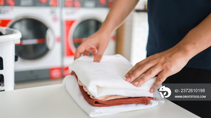 House husband with Basket and dirty laundry washed clothing in laundry room interior. washing machin