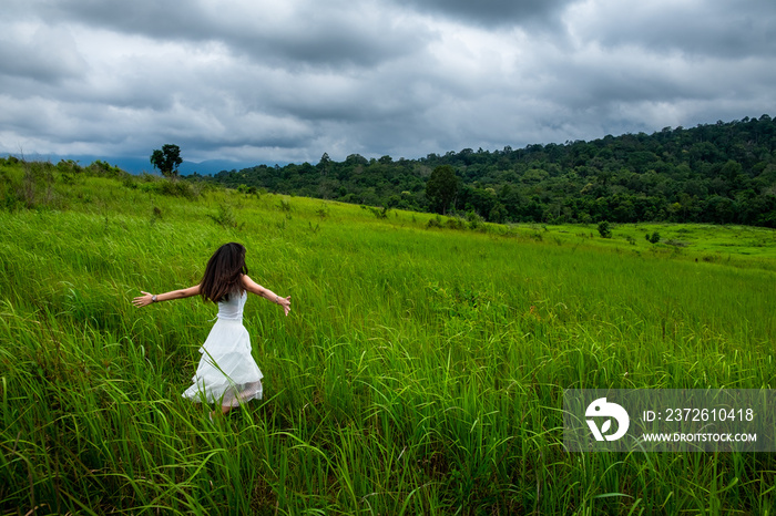 happy girl in a spring field, enjoying nature, beautiful woman in meadow,Freedom concept background.