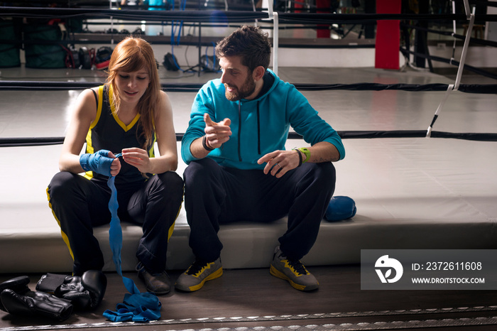 Boxing instructor and student preparing for class