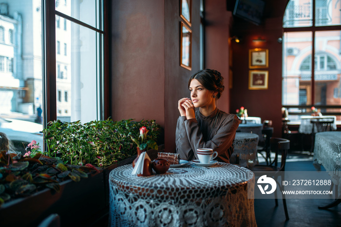 A young beautiful girl with a cup of coffee