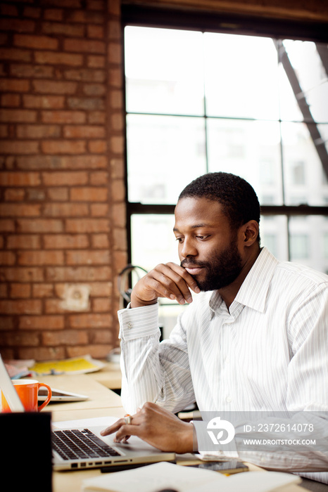 Businessman working on laptop in office