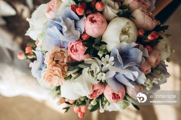 Luxury bridal bouquet with hydrangeas and peony roses. Flowers in a bouquet close-up. delicate weddi