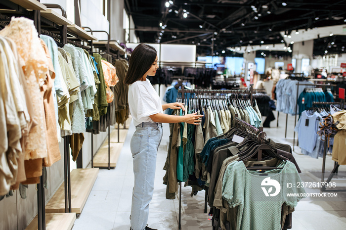 Woman choosing clothes in clothing store