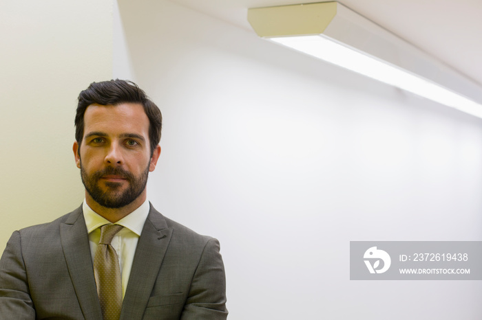 Portrait confident handsome corporate businessman in suit