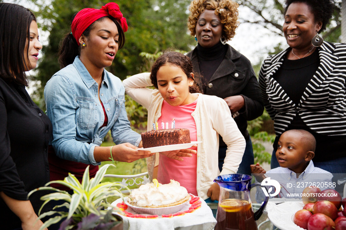 Family celebrating birthday outdoors