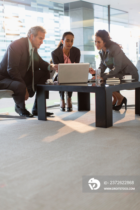 Corporate business people using laptop in office meeting