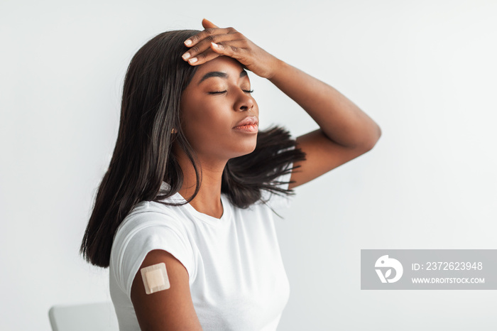 Side Effects To Vaccine. Woman With Adhesive Bandage Suffering From Fever