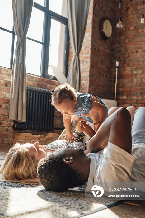 Multi ethnic happy family of two parents and daughter