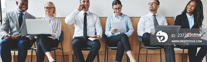 Smiling diverse businesspeople sitting together in an office rec