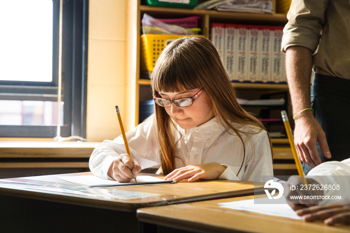 Student writing in classroom