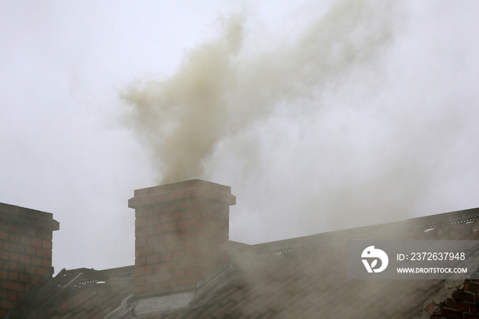 Smoke from the chimney of a house fueled with coal.