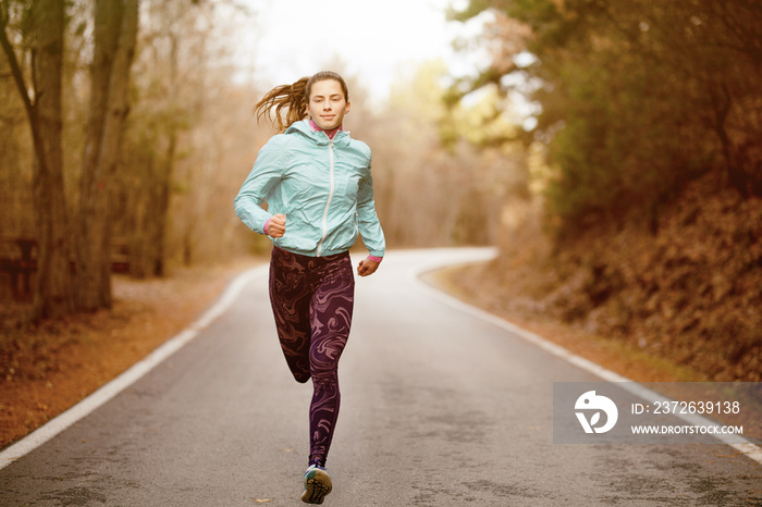 girl running on a road in the forest