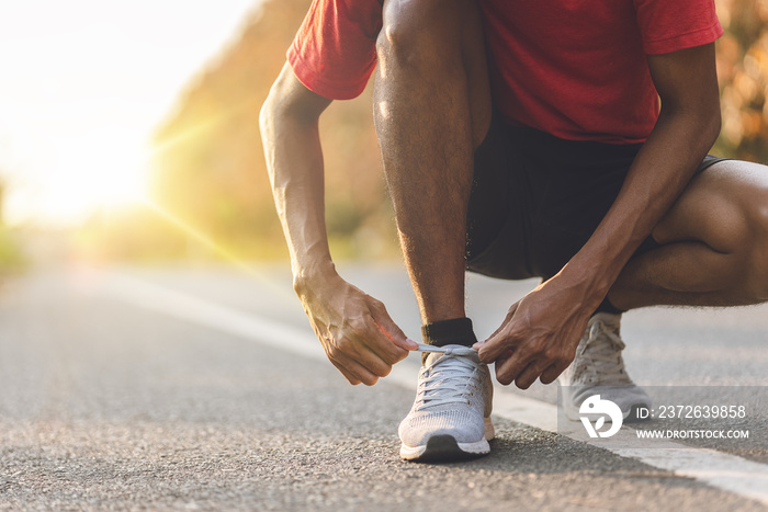 Athlete runner feet running on road, Jogging concept at outdoors. Man running for exercise.