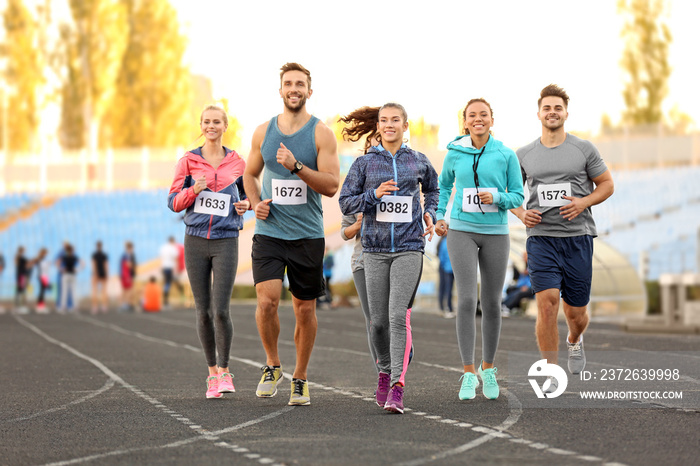 Sportsmen running at stadium