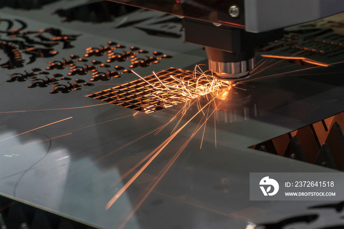 The fiber laser cutting machine cutting the sheet metal plate. The sheet metal manufacturing process