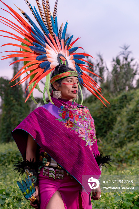 Aztec dancer in the field also known as  Chinampa  in Xochimilco, Mexico, with the traditional Aztec