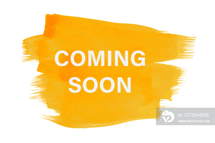 Coming soon on yellow paint background, isolated on white. Advertising banner concept.