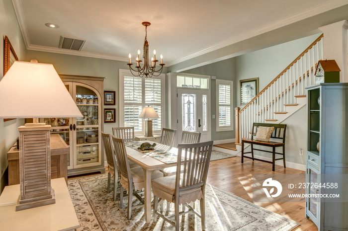 Beautiful open diningroom with light coming through door and windows.