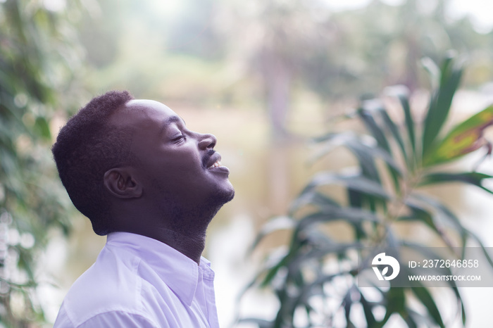 Emotional african  man laughing in wind