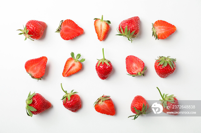 Flat lay composition with strawberries on white background, space for text. Summer sweet fruits and 