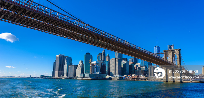 Famous Skyline of downtown New York City, Brooklin Bridge and Manhattan with skyscrapers illuminated