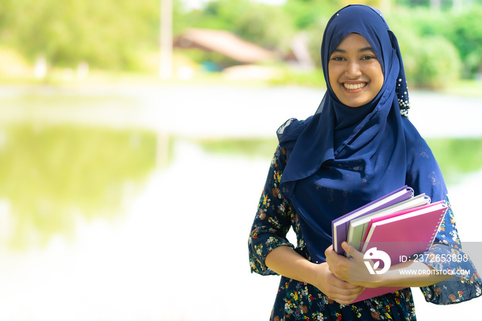 muslim girl student with books portrait