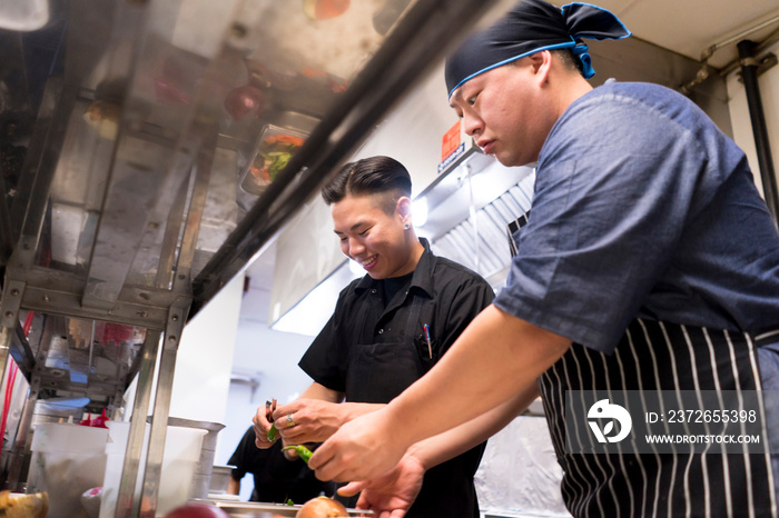 Chefs in kitchen preparing food