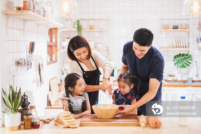 Asian family enjoy playing and cooking food in kitchen at home