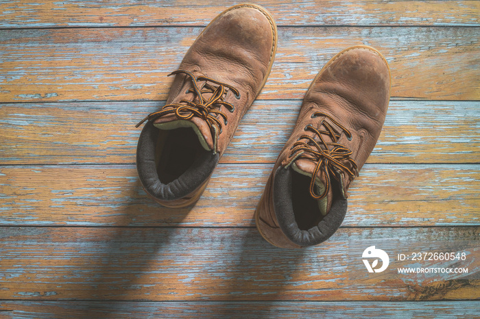 Hiking shoes laid on a wooden floor background