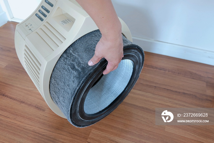 Air purifier maintenance. The dirty filter of air purifier. Filter replacement.